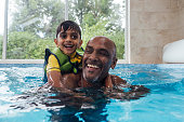 Grandad and Grandson Playfully Swimming