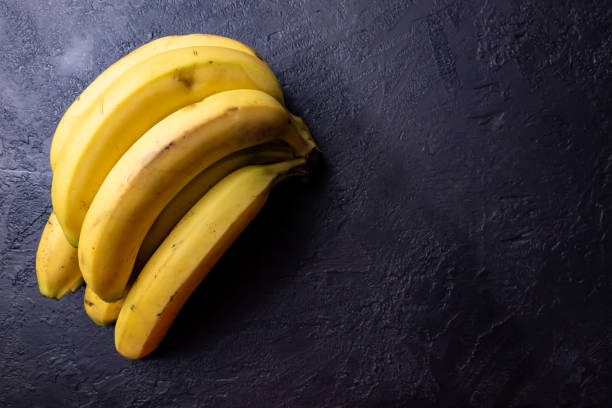 istock A bunch of bananas on a black table. 2040746466