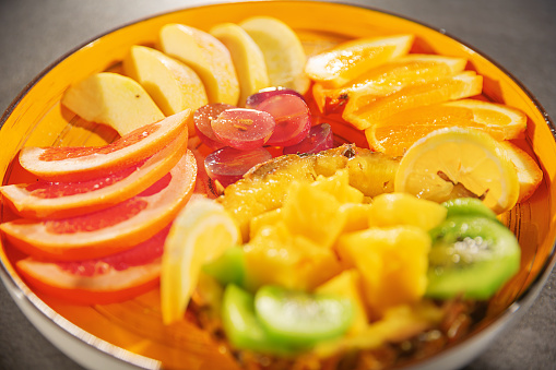 Assorted fruits on an orange plate