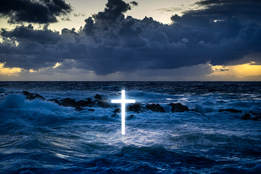 Glowing cross above the sea