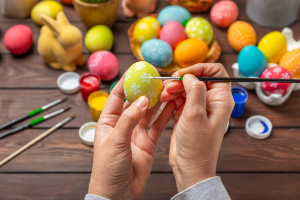 istock Easter egg painting at the kitchen table.Happy Easter celebration concept.Colorful Easter eggs with different patterns.Paints,decorations for coloring eggs for holiday.Creative background.Copy space 2040758803