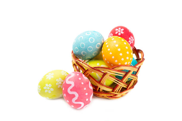 istock Easter basket filled with colorful eggs isolated on white background. Easter celebration concept. Colorful easter handmade decorated Easter eggs. 2040759313