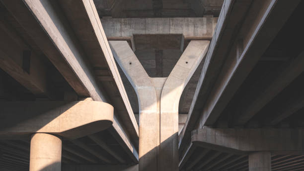 istock Geometric pattern background of concrete foundation structure of flyover and expressway with light and shadow on surface 2040767739