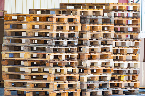 stack of empty wooden pallets for shipping goods. close-up