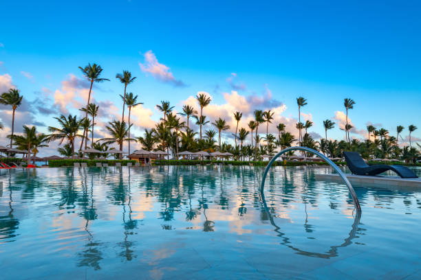 Swimming pool and palm trees in luxury resort at Pun Cana in the Dominican Republic stock photo