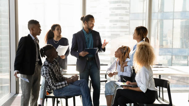 istock Young black male experienced mentor speak to interns at workshop 2040799650