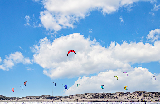 Los Caños de Meca, Barbate, Cádiz; August 19, 2022: athletes practicing kitesurfing in front of the beach of the Trafalgar Lighthouse