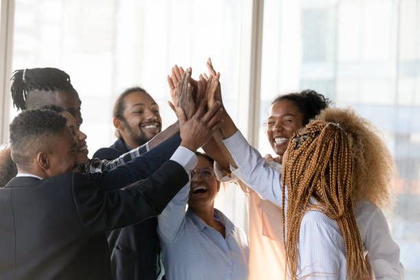 istock Diverse mixed race employees team unite hands in high five 2040843989