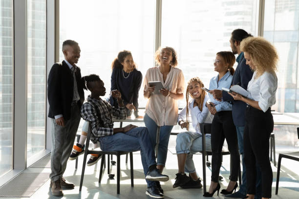 istock Positive young ethnic staff group meeting at break having fun 2040845540