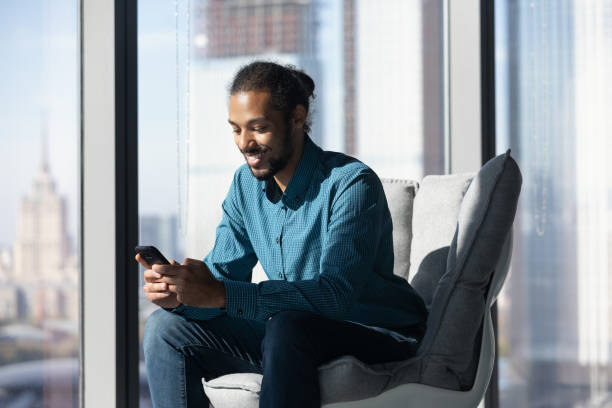 istock African employee sit at office chair by window use cell 2040852943