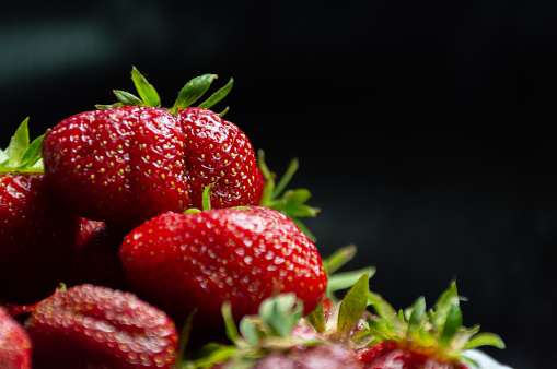 Juicy ripe strawberries on a dark background