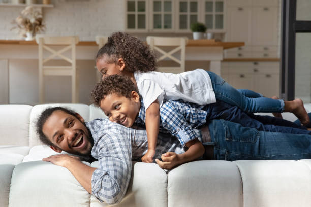 istock Joyful laughing little kids playing with father. 2040883177