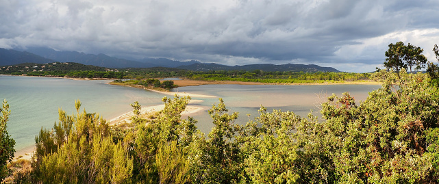 Panoramic view of the pretty lagoon bordering the small road leading to Benedettu beach in the town of Lecci in Corsica, nicknamed the Isle of Beauty.