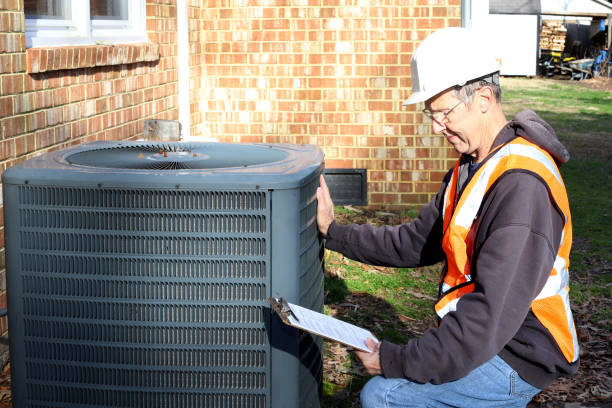 istock Home inspection of central air unit by a maintenance worker 2040912393
