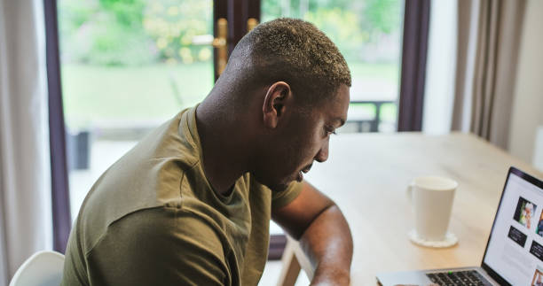 istock Remote work form home, laptop and black man with a project, startup and planning with ideas. African person, entrepreneur and consultant with a pc, writing and opportunity with research and solution 2040924211
