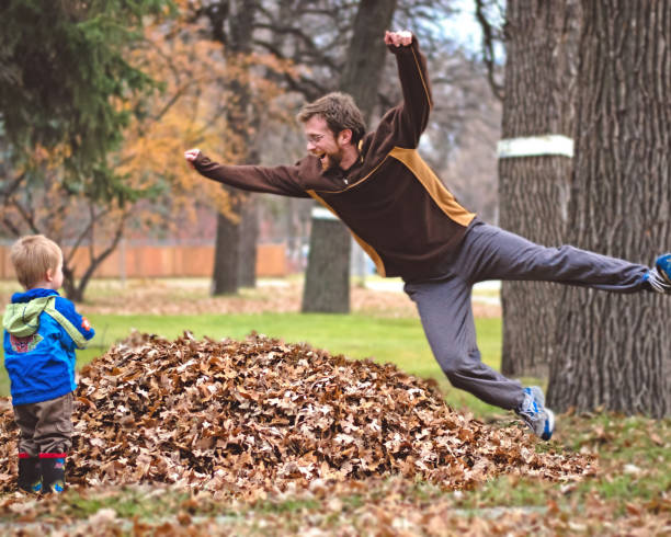 Family Bonding in Fall: Playful Leaf Jumping