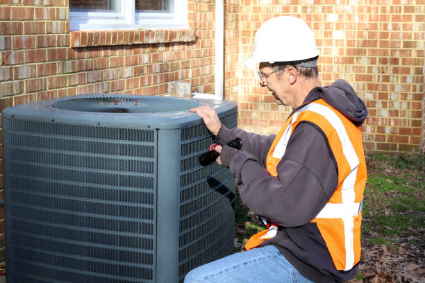 istock Home inspection of central air unit by a maintenance worker 2040933636