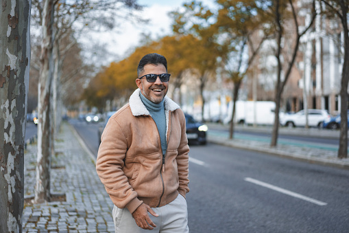 Happy mature man outdoors on the street in Lisbon, Portugal
