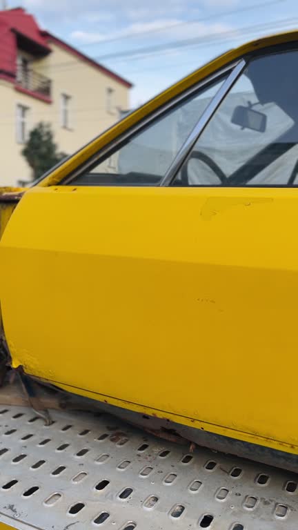 Yellow Car on a Tow Truck