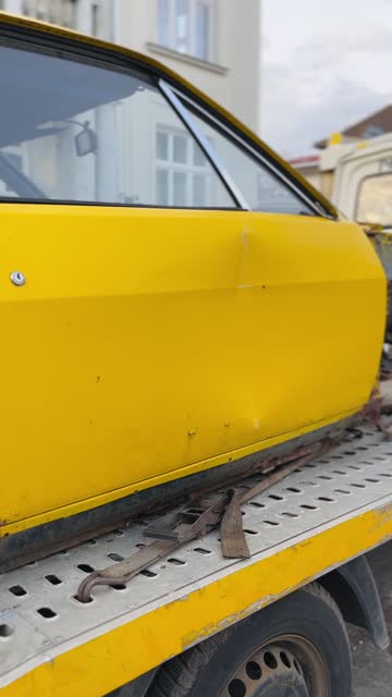 Yellow Car on a Tow Truck