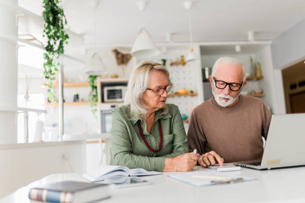 istock Senior couple using laptop while planning their home budget, 2040955445