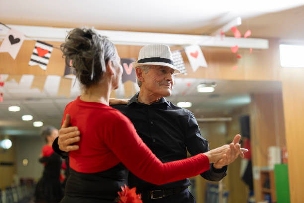 istock Positive active elderly couple enjoying slow foxtrot in dance studio. Amateur social dancing concept 2040958554