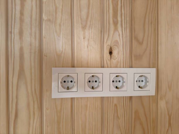 istock Electrical sockets on wooden wall. No people. 2040967895
