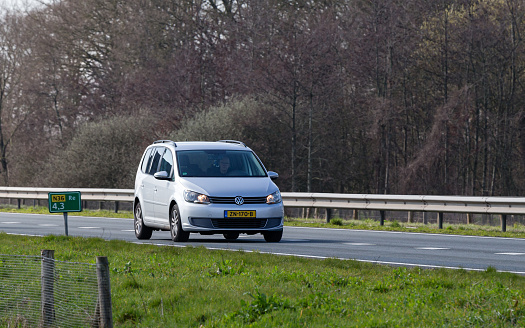 Netherlands, Overijssel, Twente, Wierden, March 19th 2023, side/front view close-up of a Dutch 2015 Volkswagen 1st generation Touran 1.4 TSI MPV driving on the N36 at Wierden, the Touran has been made by German manufacturer Volkswagen since 2003, the N36 is a 36 kilometer long highway from Wierden to Ommen
