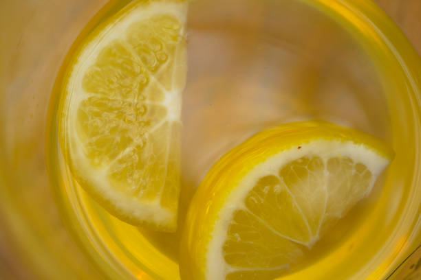 Top view of lemon tea pouring in a cup .