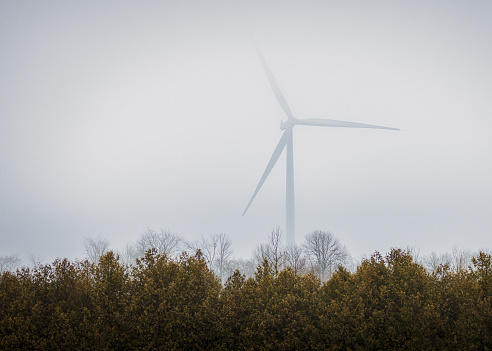Wind turbine on a foggy winter day