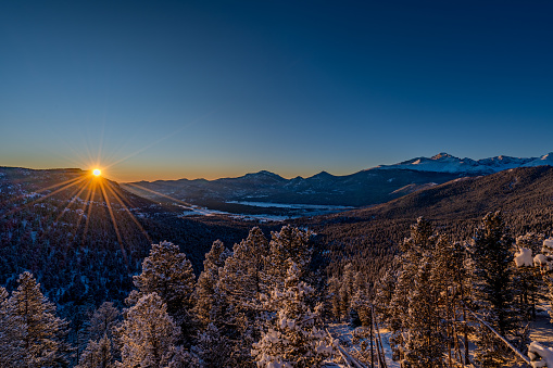 Vibrant sunrise over the extreme winter terrain of Rocky Mountain National Park near Estes Park, Colorado USA.