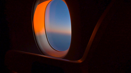 Looking out an Airplane window at sunrise or sunset with copy space