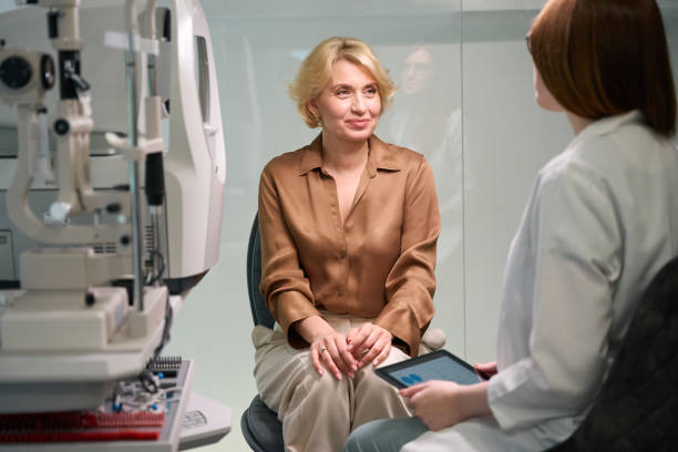 istock Red-haired ophthalmologist consults a middle-aged lady at a reception 2041017060