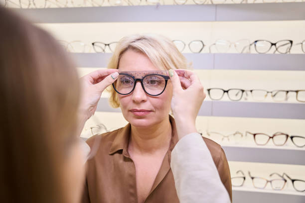 istock Specialist consultant in an optical salon works with a client 2041046347