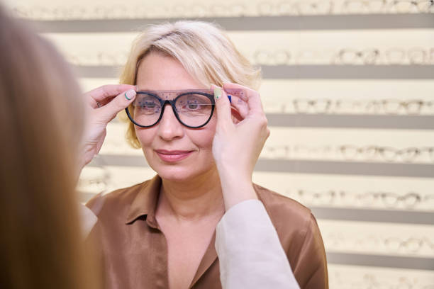istock Consultant in an optical salon works with a client 2041046353