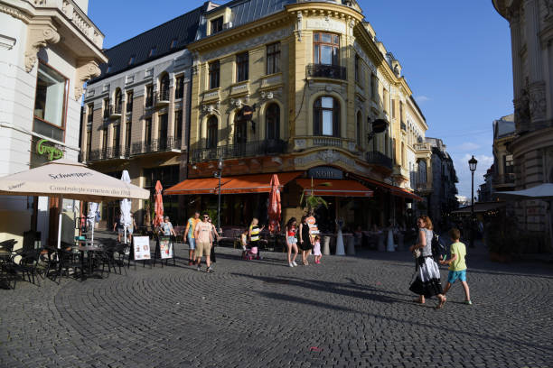 Bucharest City. The image shows the beautiful romanian capital during a sunny day in summer season with several pedestrians.