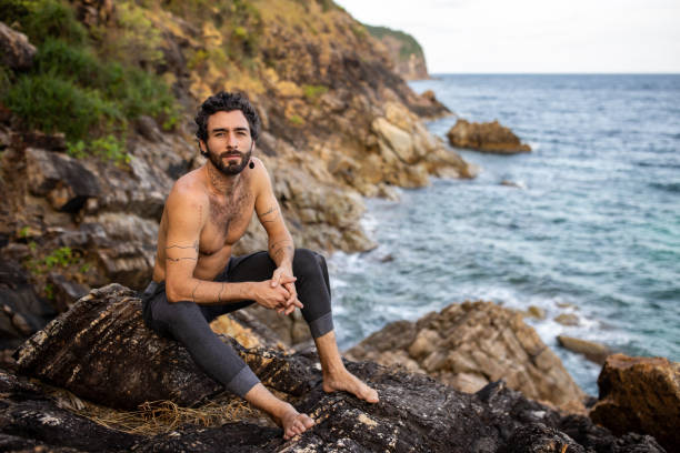 istock Handsome man sitting by the sea 2041073275