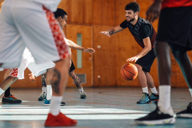 istock Basketball player dribbling a ball during training with his teammates. 2041100506