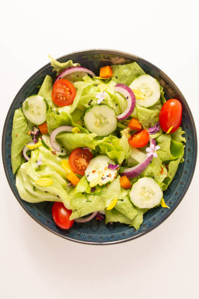 istock Fresh healthy green salad with tomatoes and vegetables in front view clean background 2041103185
