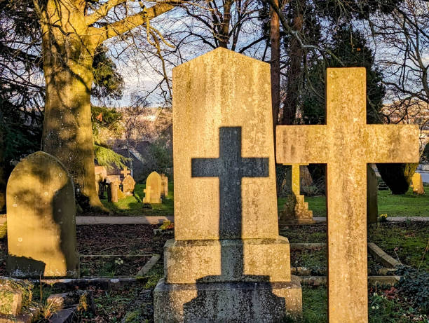 istock Shadow of a cross in a graveyard 2041117308