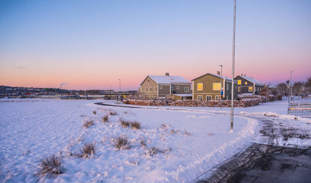 istock Bicycle path past houses on a snowy morning. 2041135312