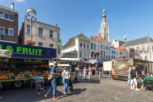 Breda, Netherlands, September 15, 2023; People at the market on the Grote Markt in Breda with a view of the Church of Our Lady.