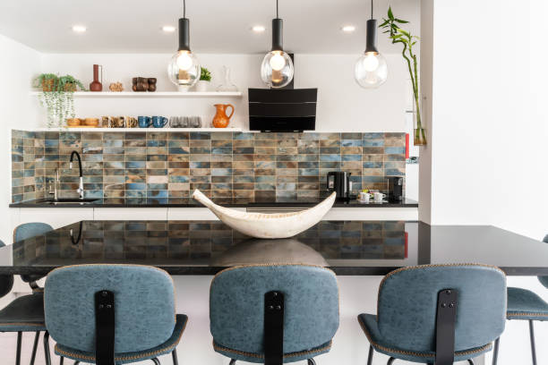 istock Beautiful kitchen in luxury home with marble table and chairs and a kitchen counter in the background 2041138979