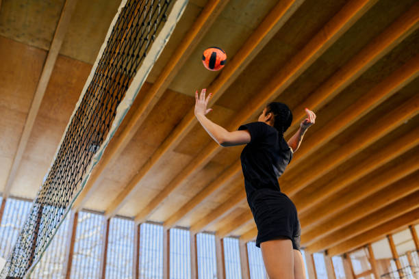 istock Low angle view of interracial volleyball player hitting a ball over net. 2041149966