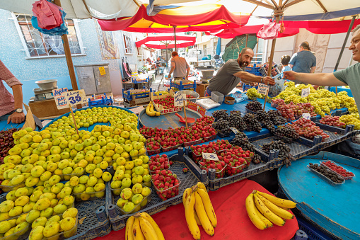 Eskisehir, Turkey - Aug 2, 2023: Amidst charming stalls of Eskisehir's market, locals and visitors indulge in a feast for the senses, exploring a rich array of fresh, locally sourced fruits.