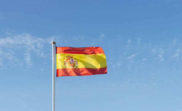 istock Spain's national flag fluttering in a clear blue sky. 2041168038