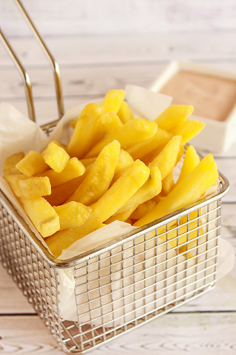 FRENCH FRIES Bucket Closeup served in dish isolated on table side view of arabic fastfood