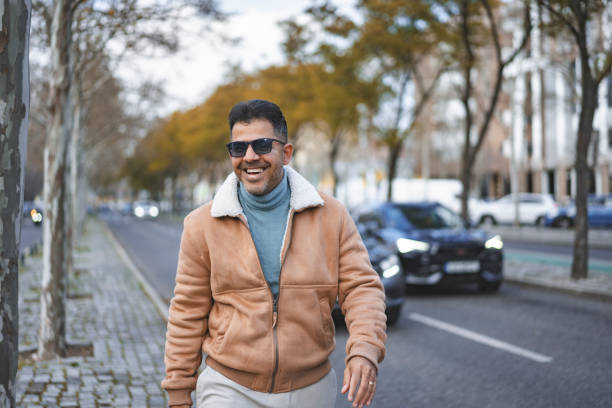 Mature man smiling outdoors on the streets of Lisbon, Portugal