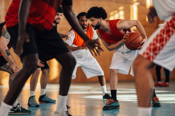 istock A hispanic basketball player defending ball during training with team. 2041197286