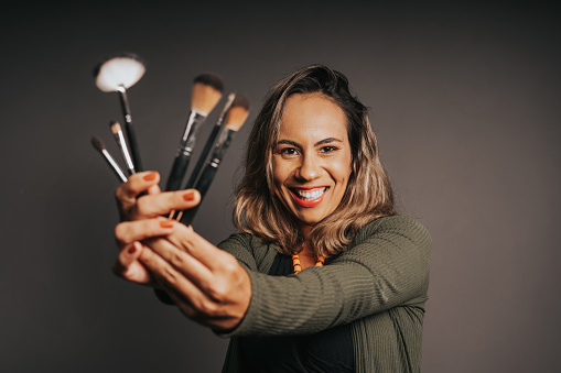 Woman holding makeup brushes